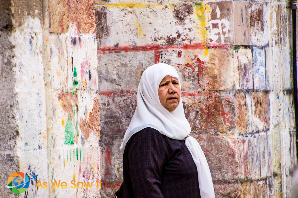 This Arab women was shy about having her picture taken, but the contract of her white head cover against the colorful old city wall was captivating.