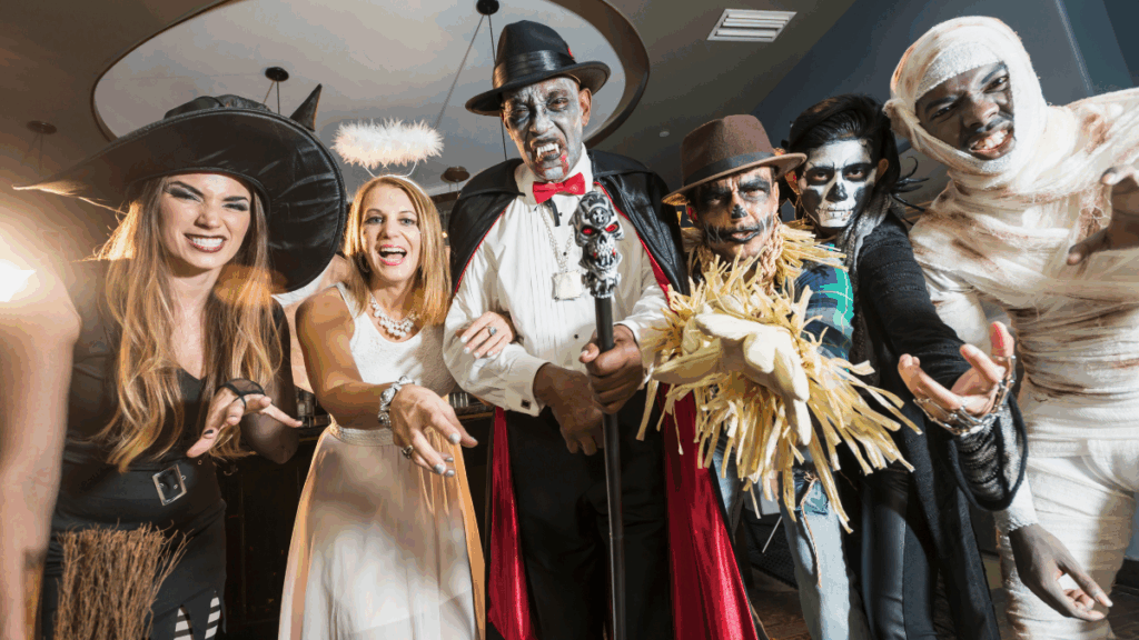 Adults in scary Halloween costumes (vampire, mummy), representing the secular or darker aspects of the holiday.